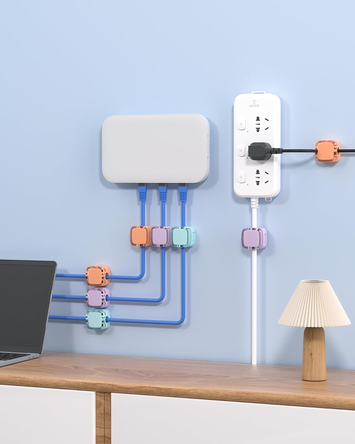 Magnetic cable clips organizing charging cables beside a wall outlet