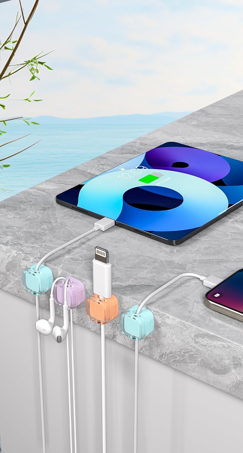 Magnetic cable clips holding a phone charging cable on a desktop