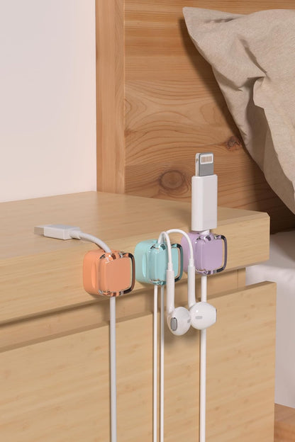 Magnetic cable clips attached to a nightstand for easy cable access