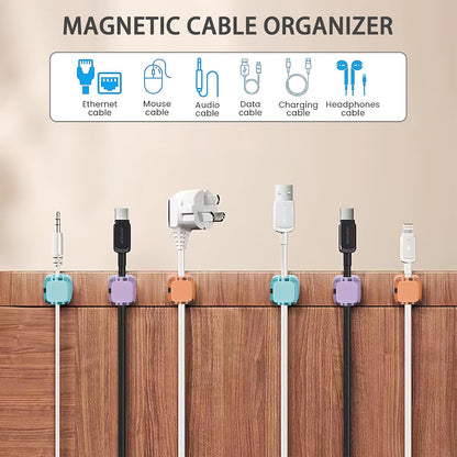 Magnetic cable clips organizing multiple cords along a wooden desk